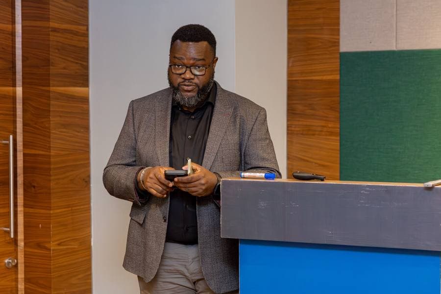 Victor Sonde presenting at a lectern